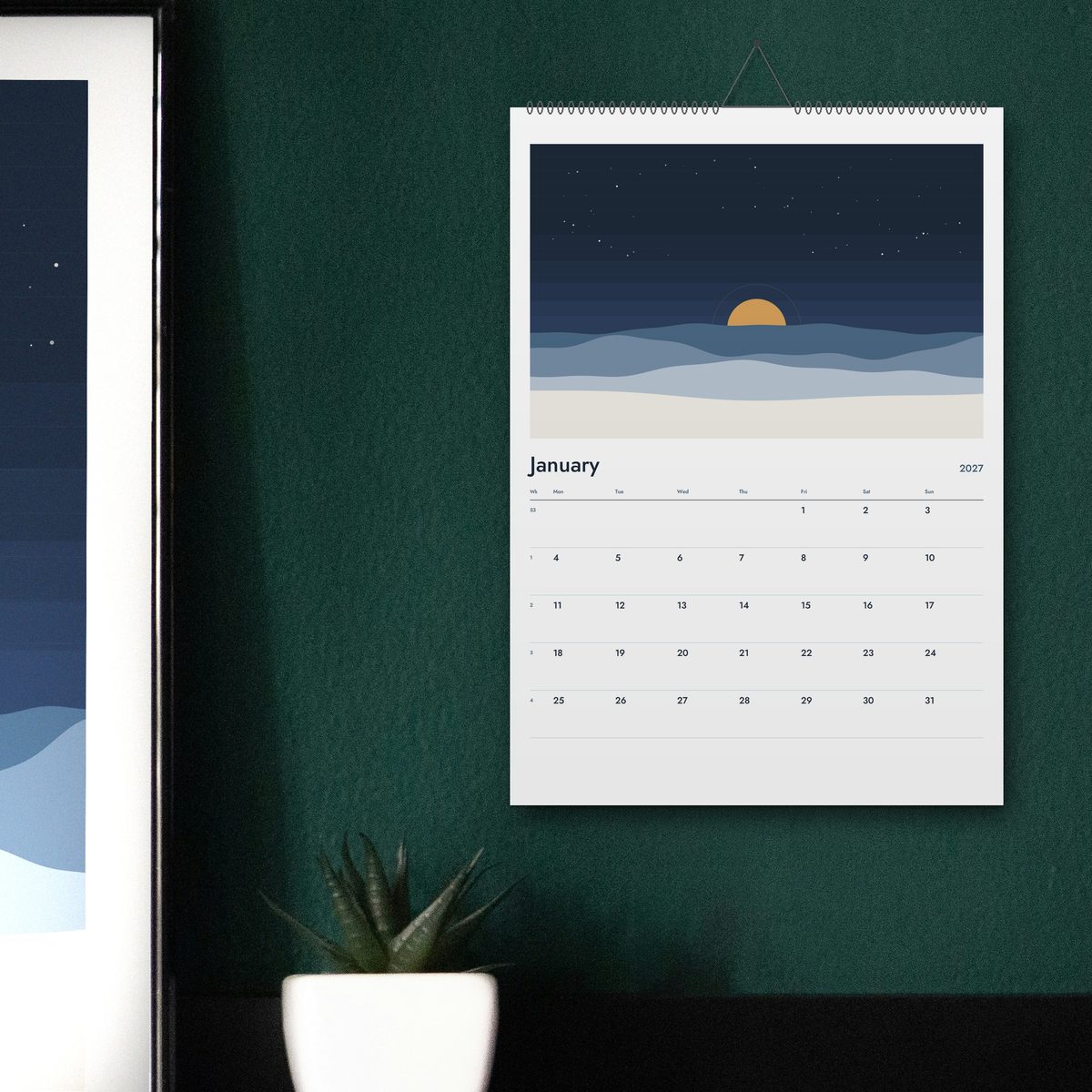 The 2027 wall calendar hanging on a green wall