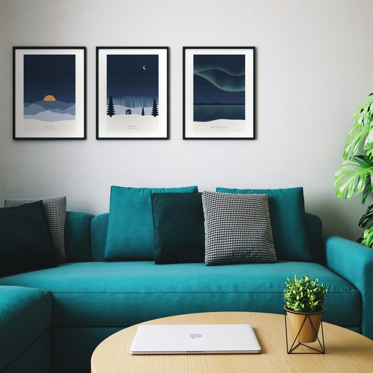 Set of three winter prints hanging above a sofa